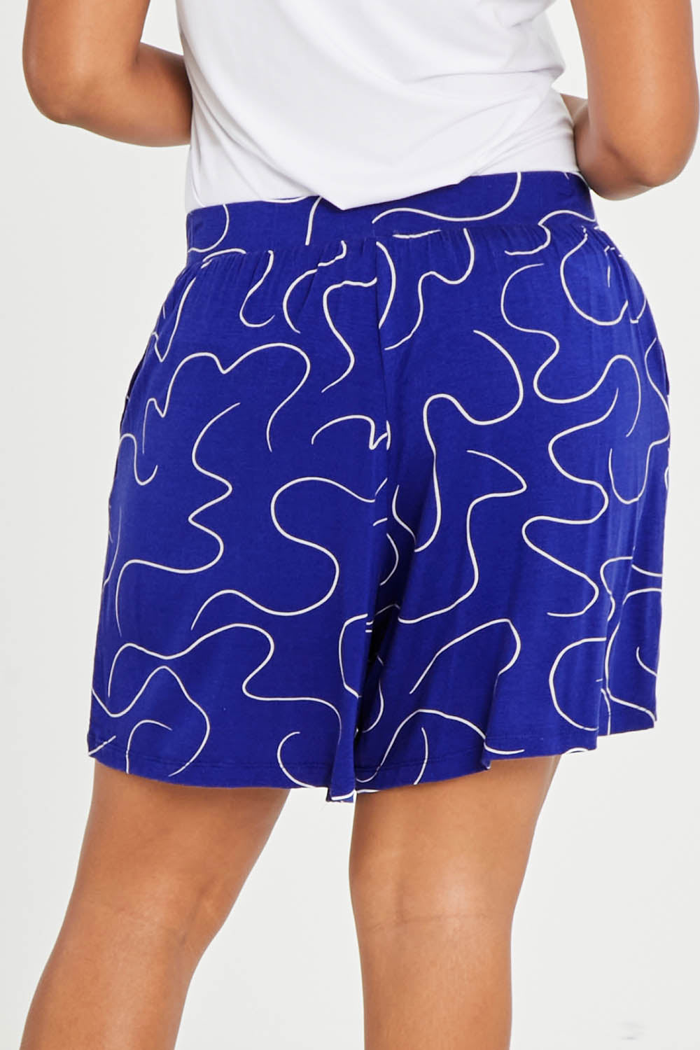 Model Noli wearing size 14 of The Printed Summer Jersey Short in colour Royalblue (Blue), from the back