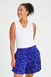Model Noli wearing size 14 of The Printed Summer Jersey Short in colour Royalblue (Blue), from the front, cropped image