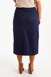 Model Monique wearing size 14 of The 5 Pocket Denim Midi Skirt in colour Navy (Blue), from the back