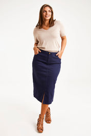 Model Monique wearing size 14 of The 5 Pocket Denim Midi Skirt in colour Navy (Blue), from the front, showing the whole outfit