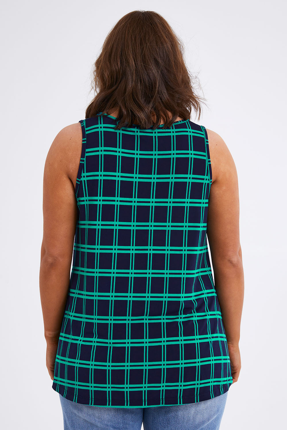 Model Monique wearing size 14 of The Printed Drape Tank in colour Navycheck (Blue), from the back