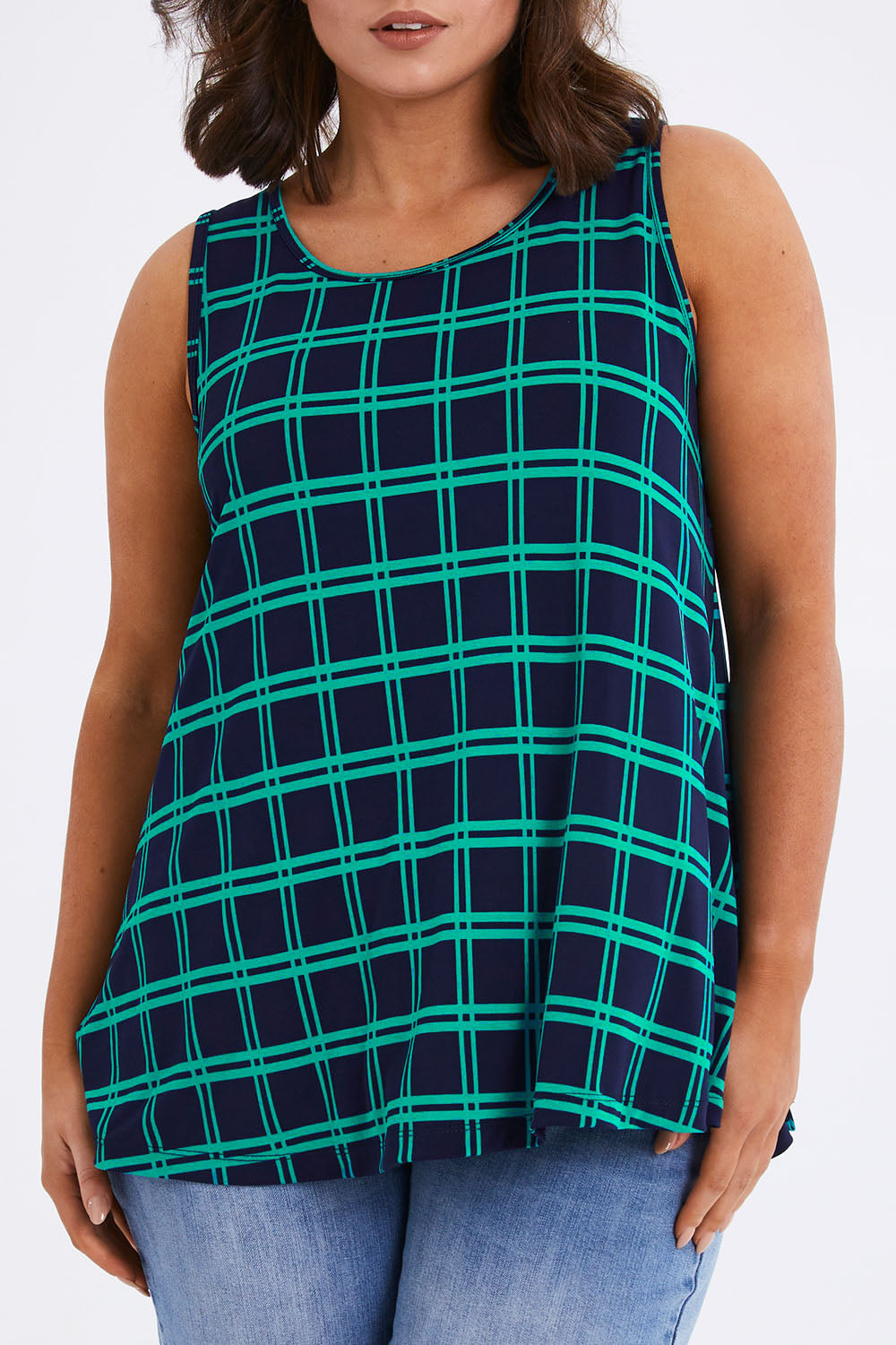 Model Monique wearing size 14 of The Printed Drape Tank in colour Navycheck (Blue), from the front, cropped image