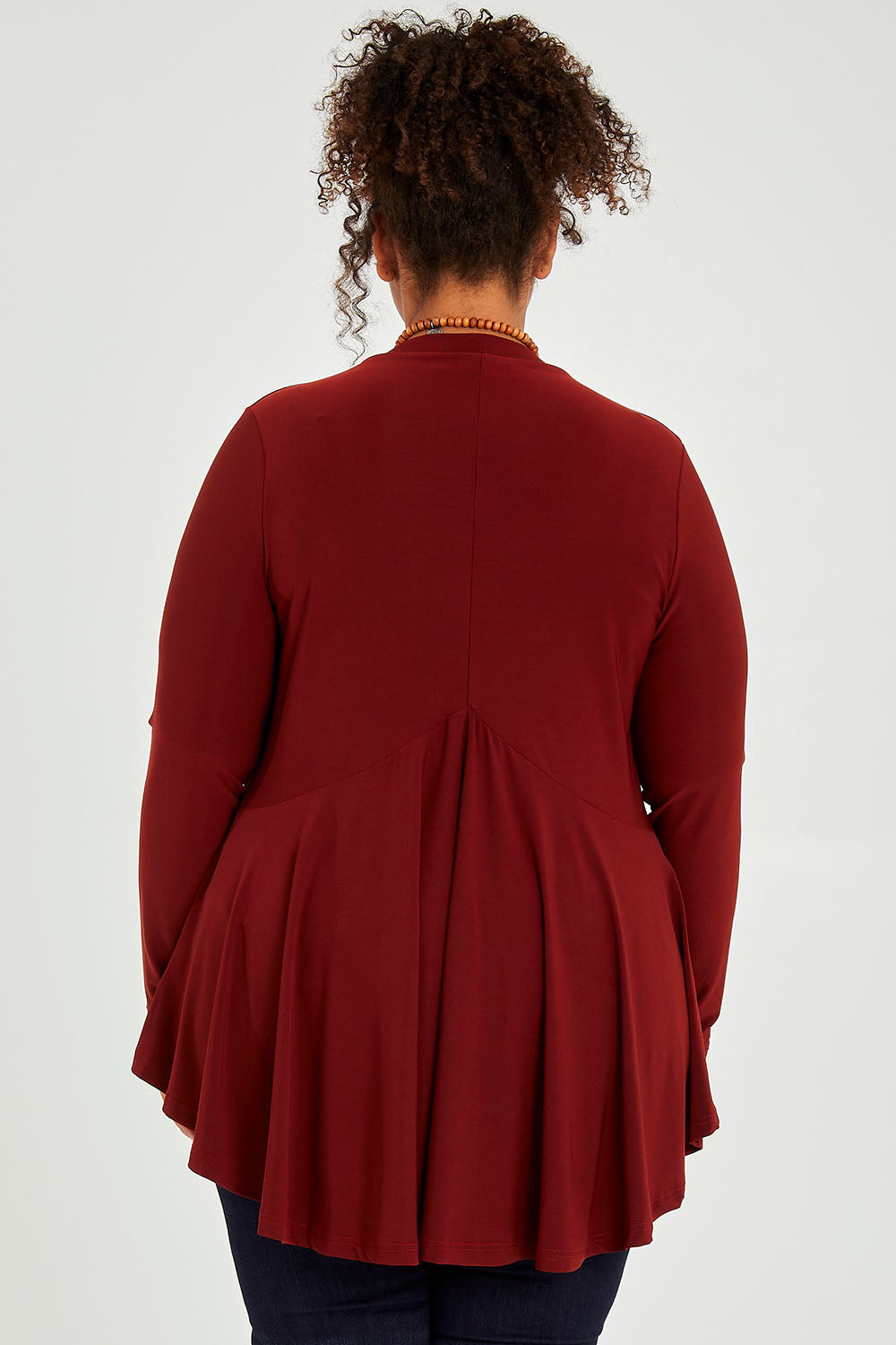 Model Alexis wearing size 16 of The Recycled Flounce Cardigan in colour Terracotta, from the back