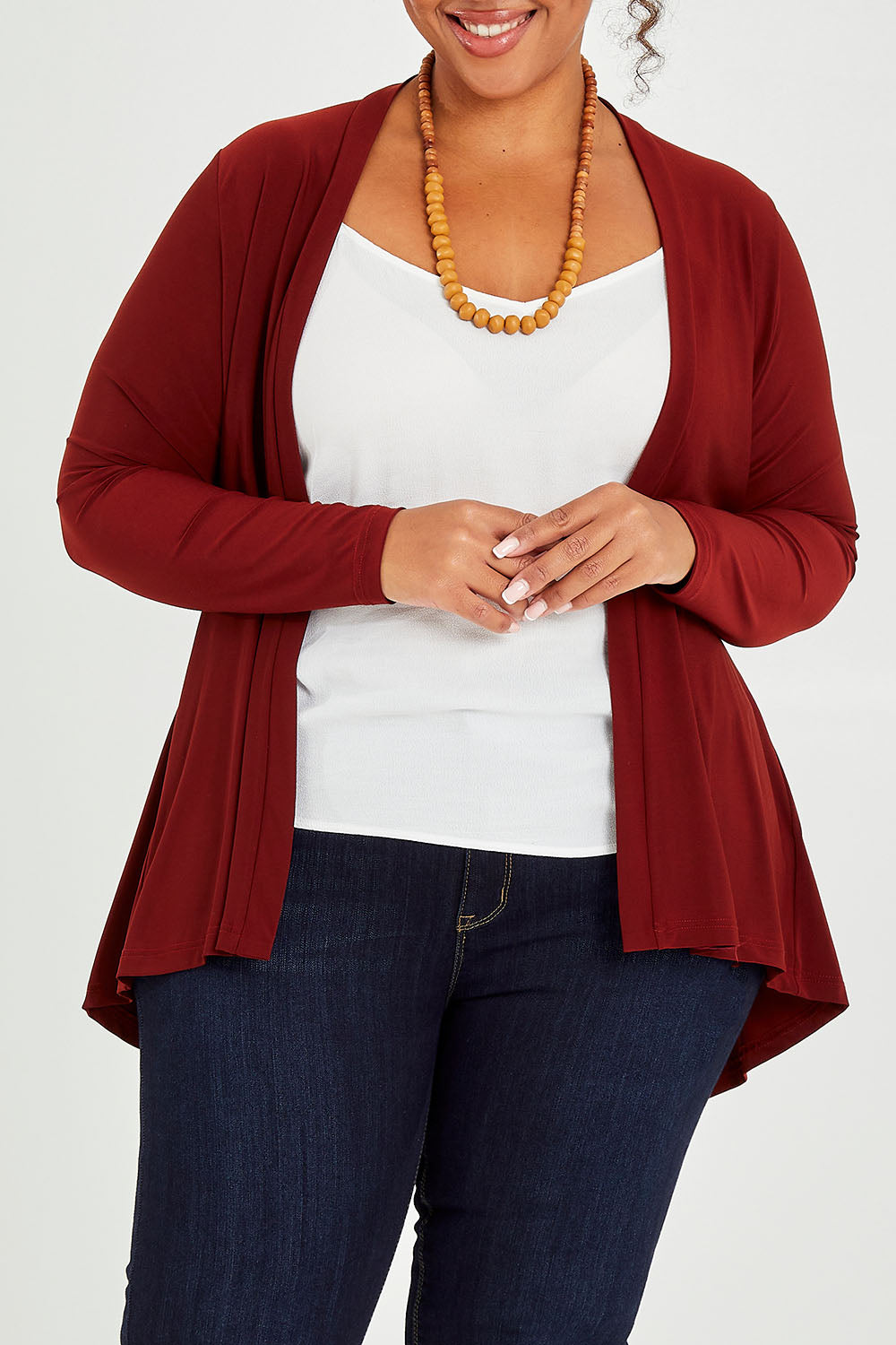 Model Alexis wearing size 16 of The Recycled Flounce Cardigan in colour Terracotta, from the front, cropped image