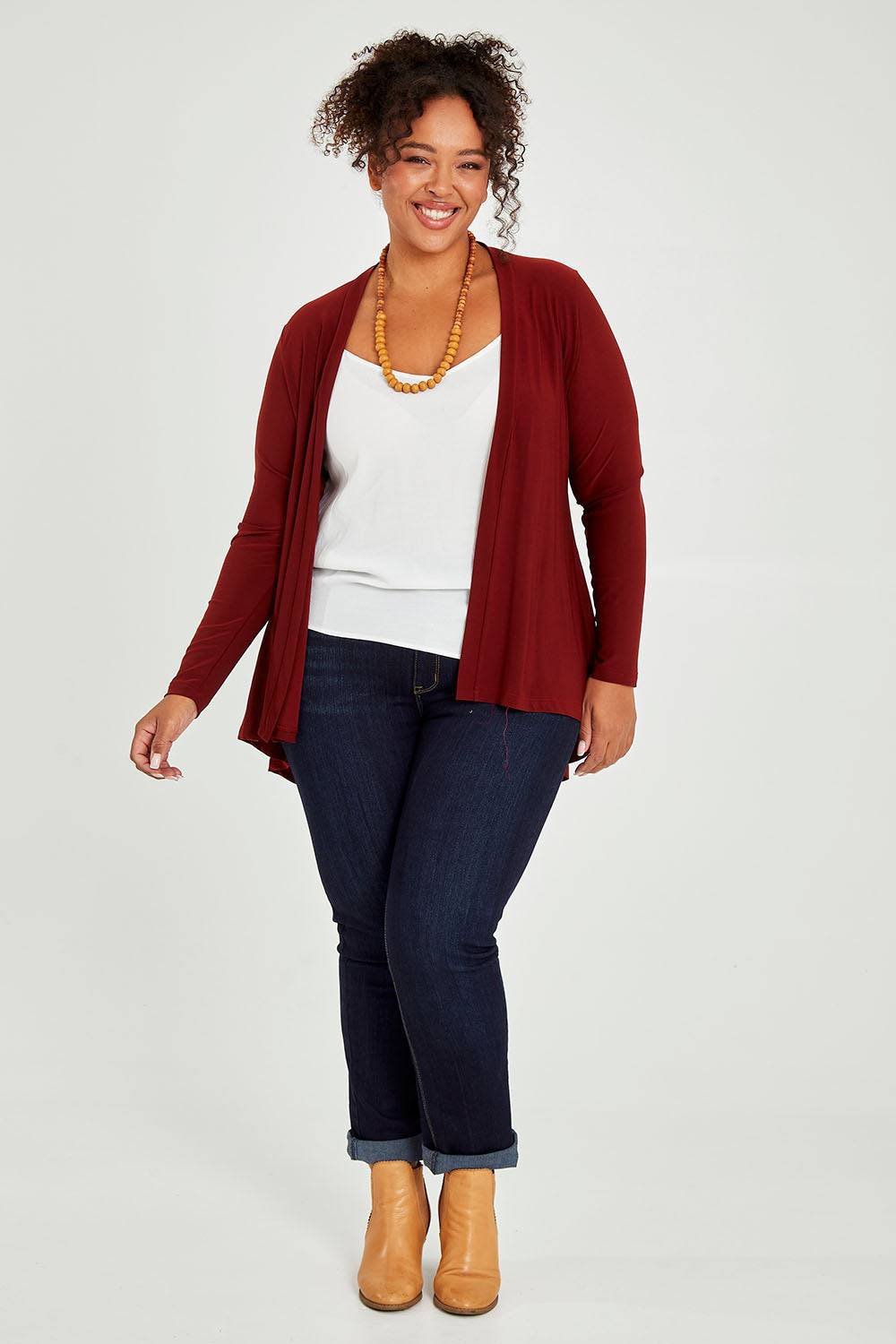 Model Alexis wearing size 16 of The Recycled Flounce Cardigan in colour Terracotta, from the front, showing the whole outfit