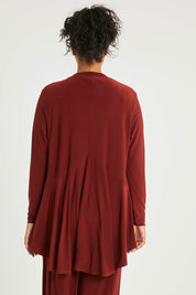 Model Noli wearing size 14 of The Recycled Flounce Cardigan in colour Terracotta, from the back