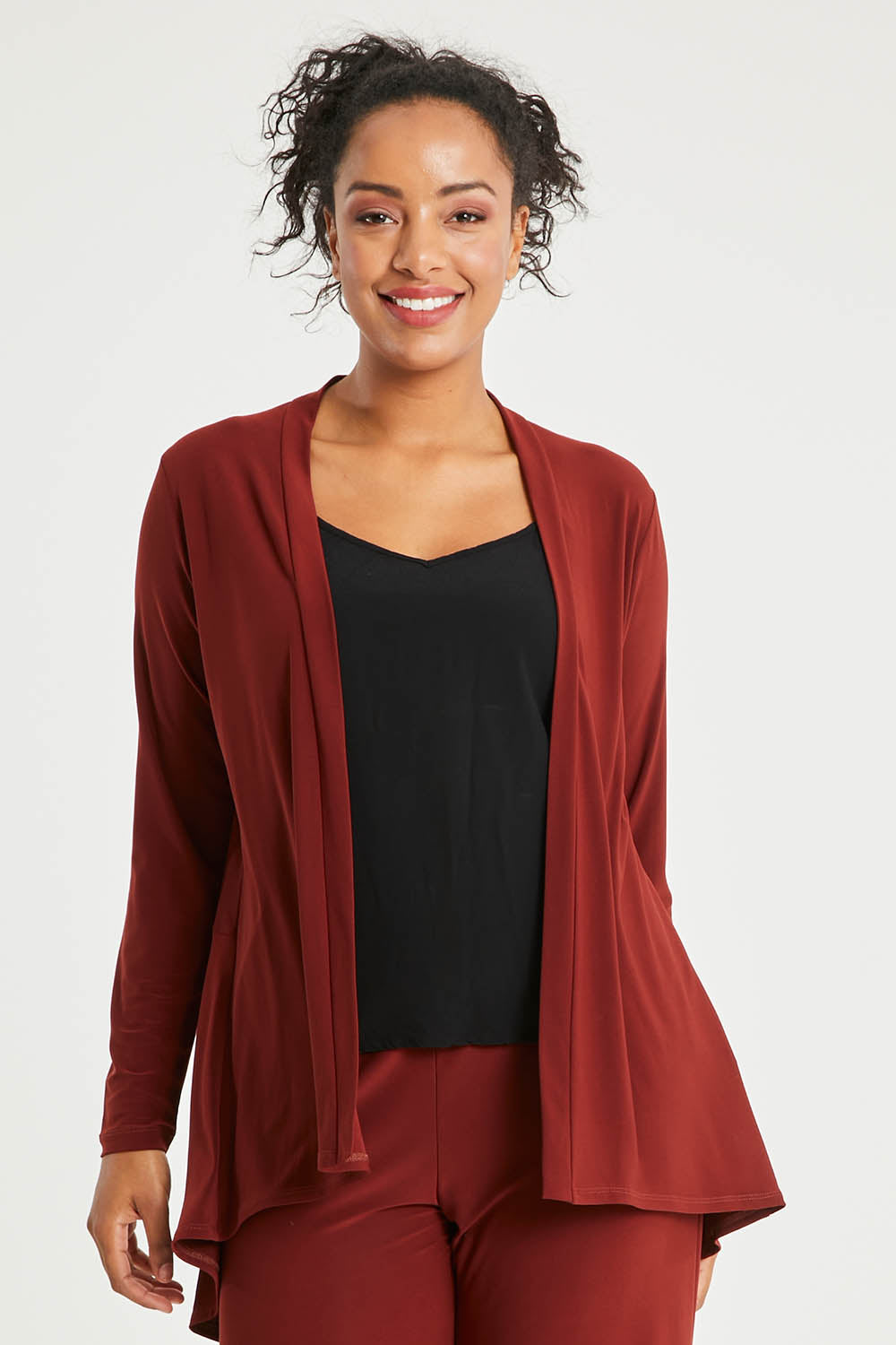 Model Noli wearing size 14 of The Recycled Flounce Cardigan in colour Terracotta, from the front, cropped image