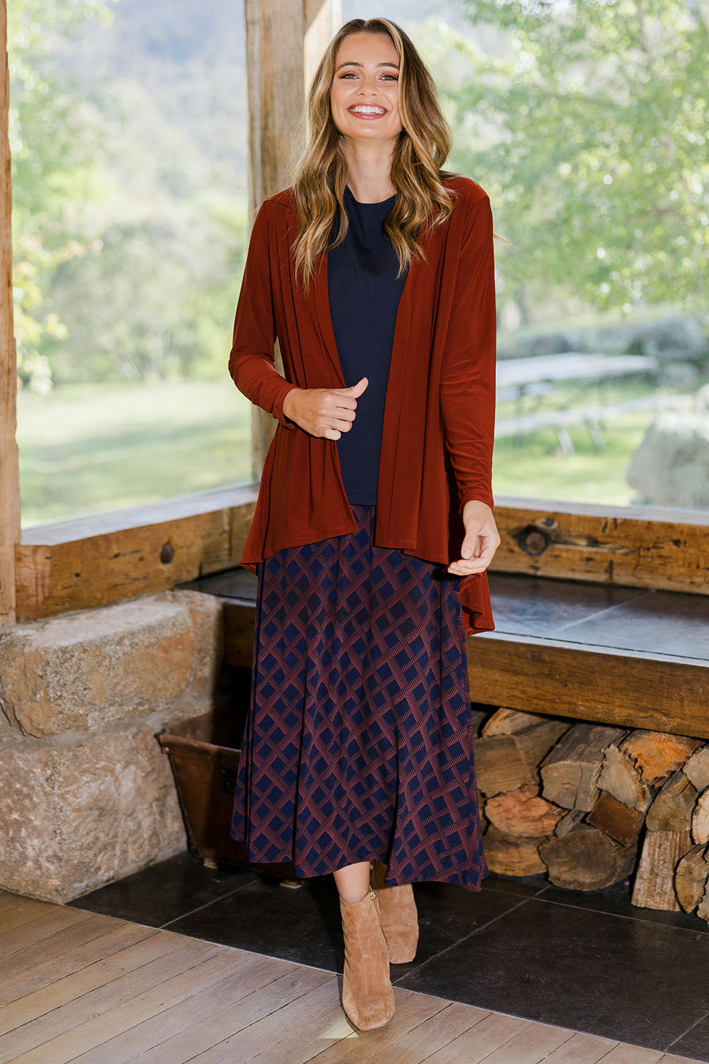 Model Tahlia wearing size 10 of The Recycled Flounce Cardigan in colour Terracotta, from the front, showing the whole outfit