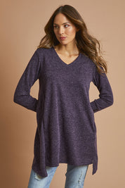 Model Madeline wearing size 10 of The Keepers Knit Tunic in colour Plum (Purple), from the front, showing the whole outfit