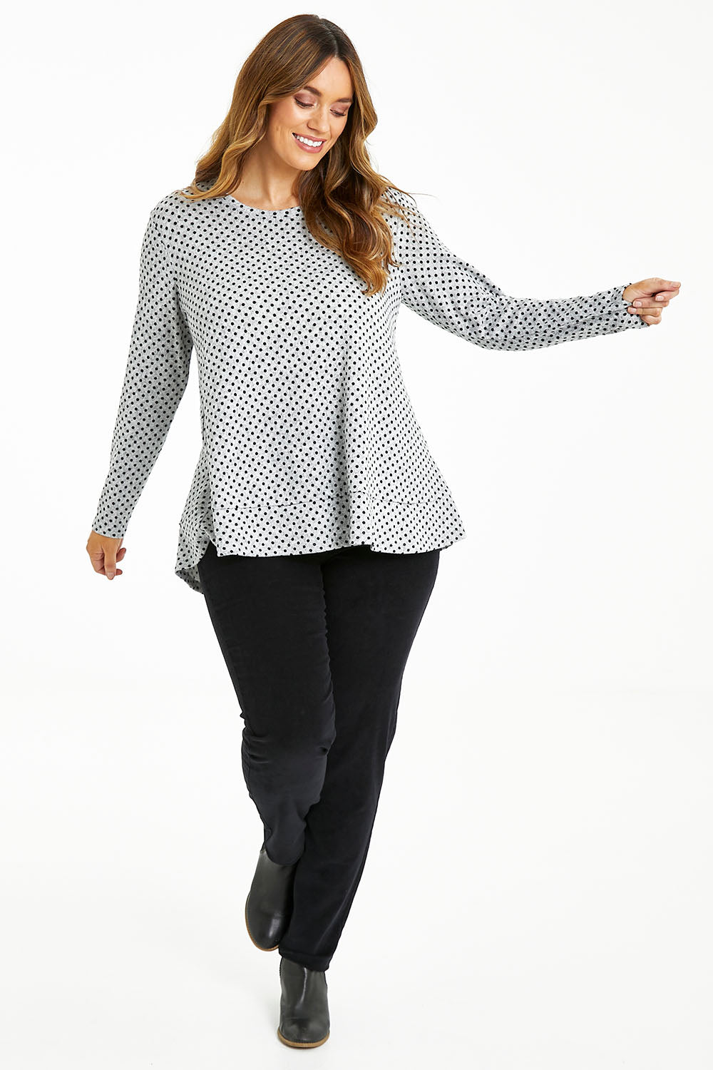 Model Laura wearing size 14 of The Spot Swing Knit Tee in colour Greymarle (Grey), from the front, showing the whole outfit