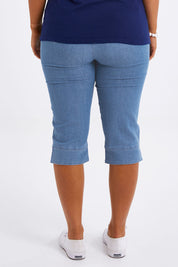 Model Monique wearing size 14 of The Cotton Blend 3/4 Pant in colour Chambray (Blue), from the back