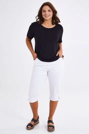 Model Monique wearing size 14 of The Cotton Blend 3/4 Pant in colour White (White), from the front, showing the whole outfit