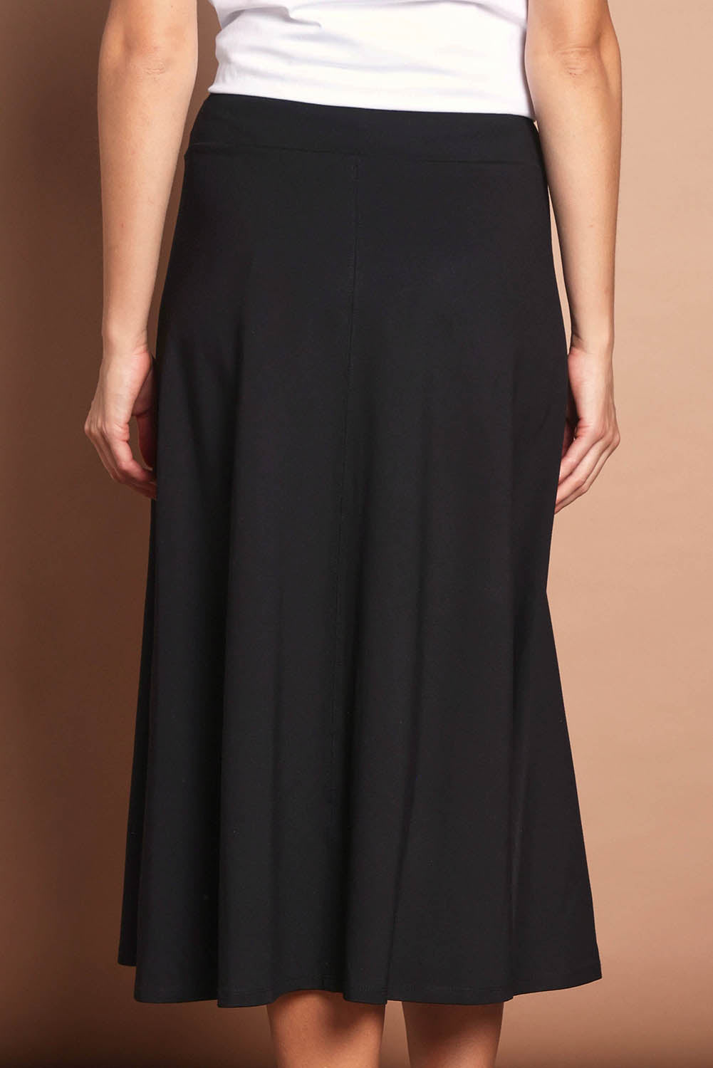 Model Madeline wearing size 10 of The Fit & Flare Summer Skirt in colour Black (Black), from the back