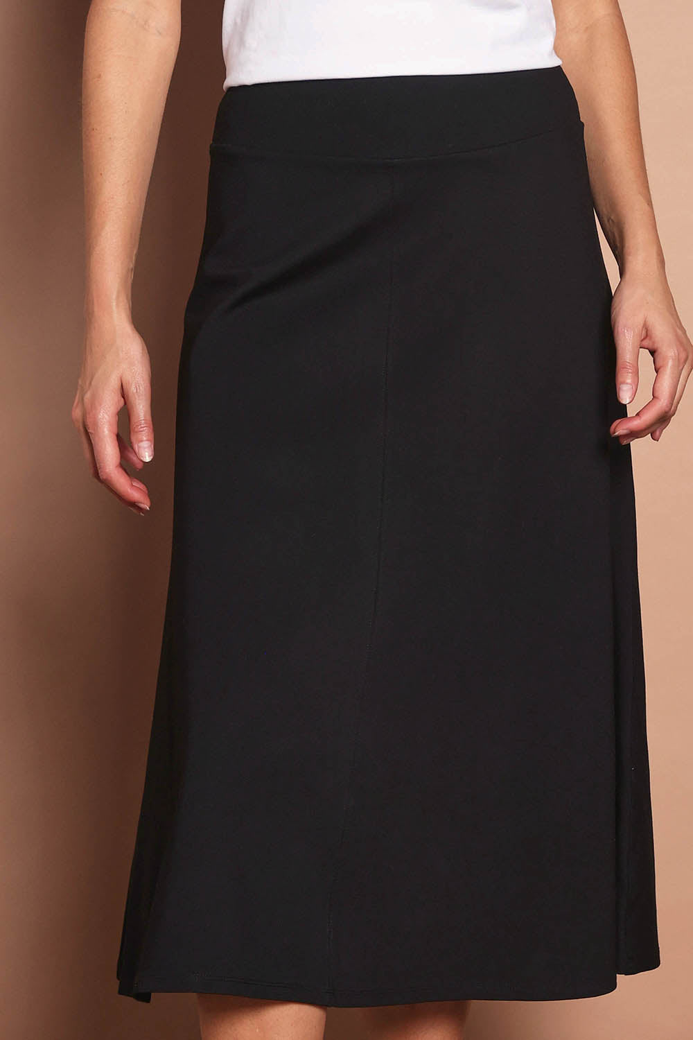 Model Madeline wearing size 10 of The Fit & Flare Summer Skirt in colour Black (Black), from the front, cropped image