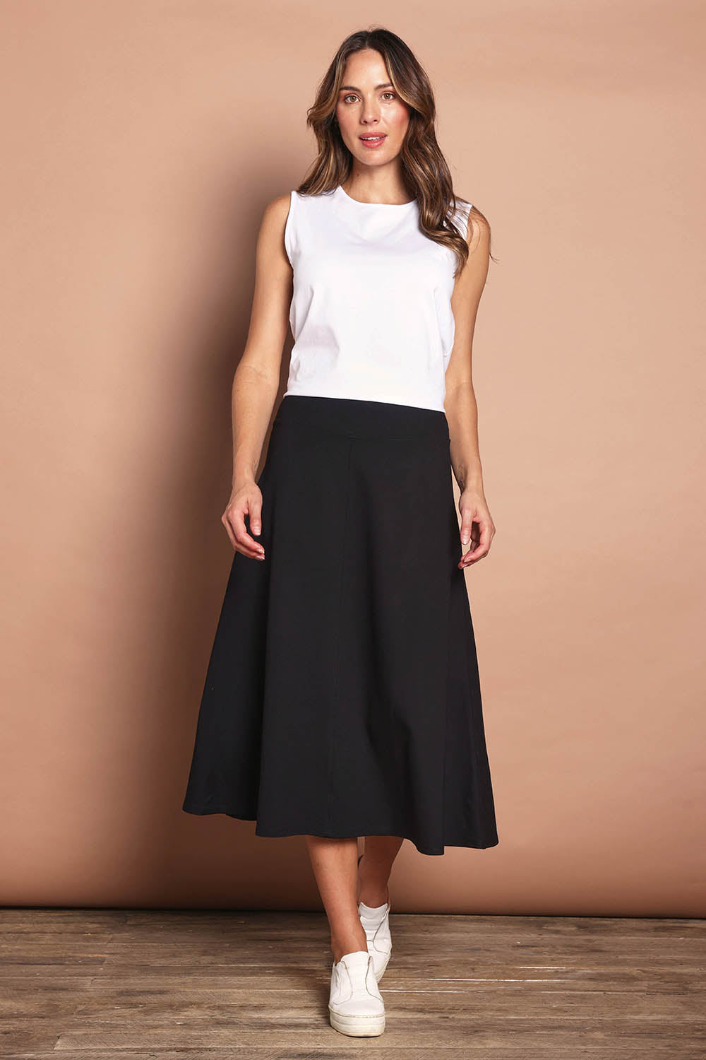 Model Madeline wearing size 10 of The Fit & Flare Summer Skirt in colour Black (Black), from the front, showing the whole outfit
