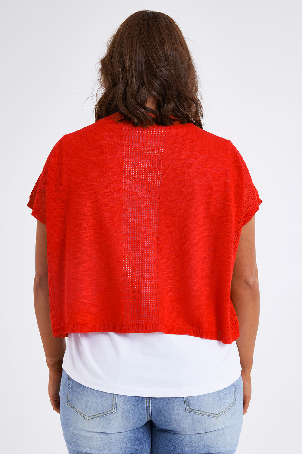 Model Monique wearing size L of The Short Sleeve Shrug in colour Red (Red), from the back