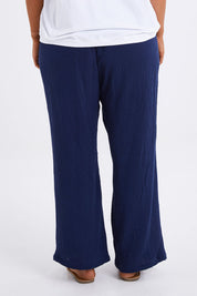 Model Monique wearing size 14 of The Double Cotton Pull On Pant in colour Navy (Blue), from the back