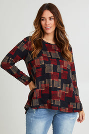 Model Laura wearing size 14 of The Printed Knit Swing Tee in colour Navycheck (Blue), from the front, cropped image