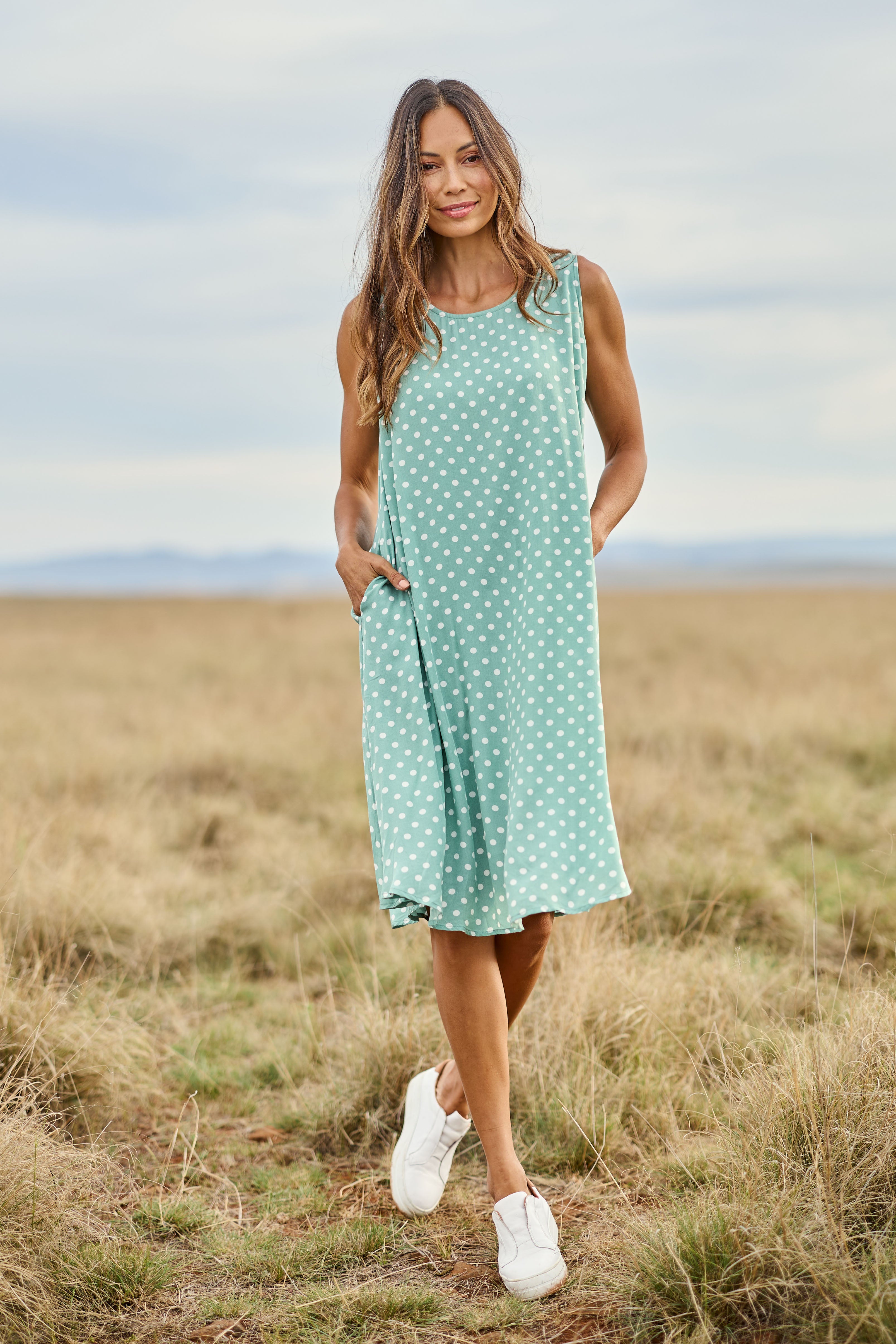 Model Amanda wearing size 10 of The Keepers Lined Swing Dress in colour Sagegreen (Green), from the front, showing the whole outfit