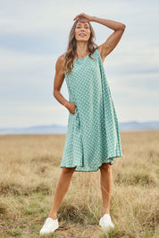 Model Amanda wearing size 10 of The Keepers Lined Swing Dress in colour Sagegreen (Green), from the front, showing the whole outfit