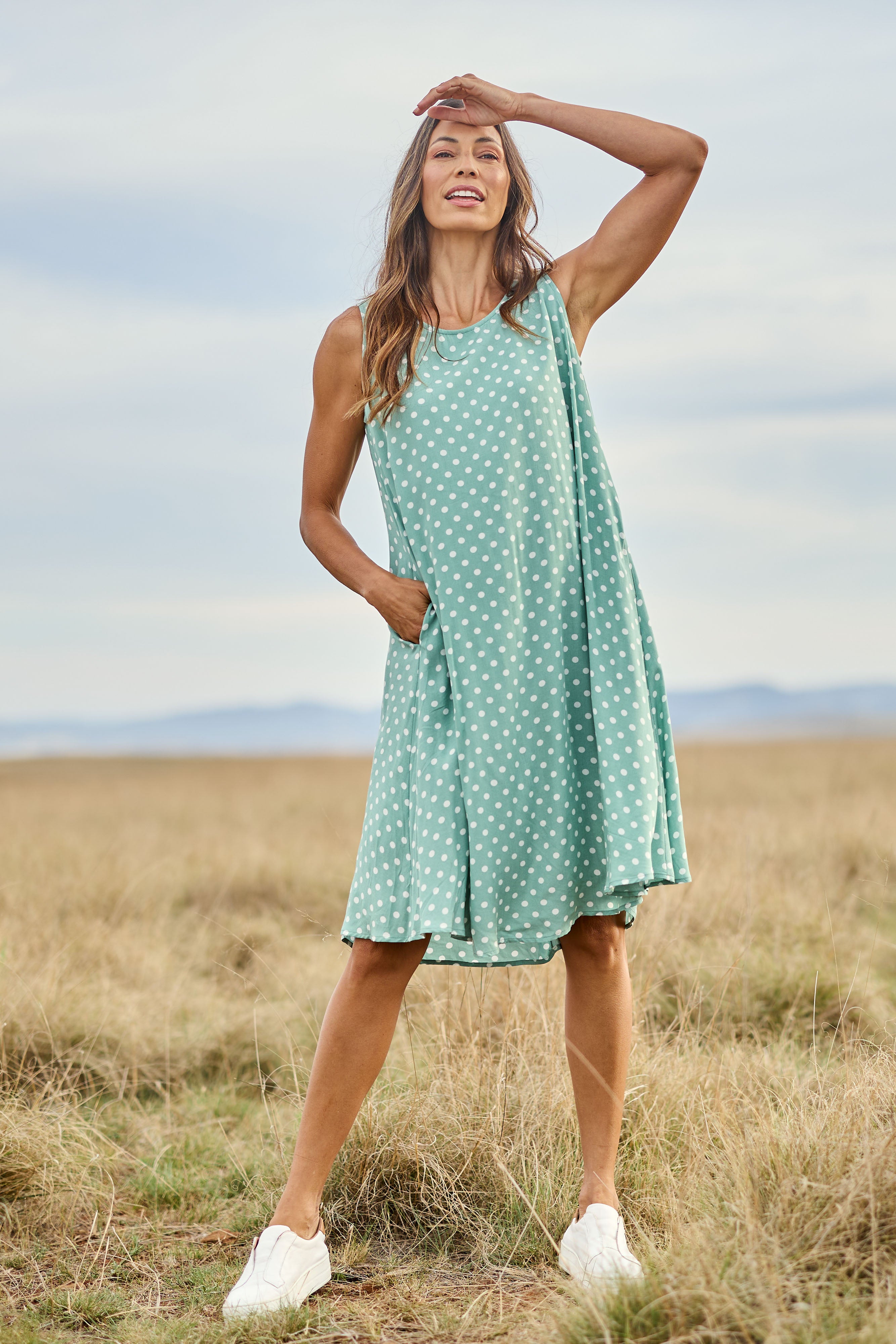 Model Amanda wearing size 10 of The Keepers Lined Swing Dress in colour Sagegreen (Green), from the front, showing the whole outfit