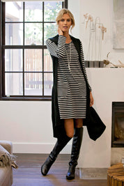 Model Natalie wearing size 8 of The Stripe Swing Dress in colour BlackGrey (Grey), from the front, showing the whole outfit
