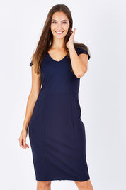 Model Anna wearing size 10 of The Deep V Neck Dress in colour Navy (Blue), from the front, cropped image