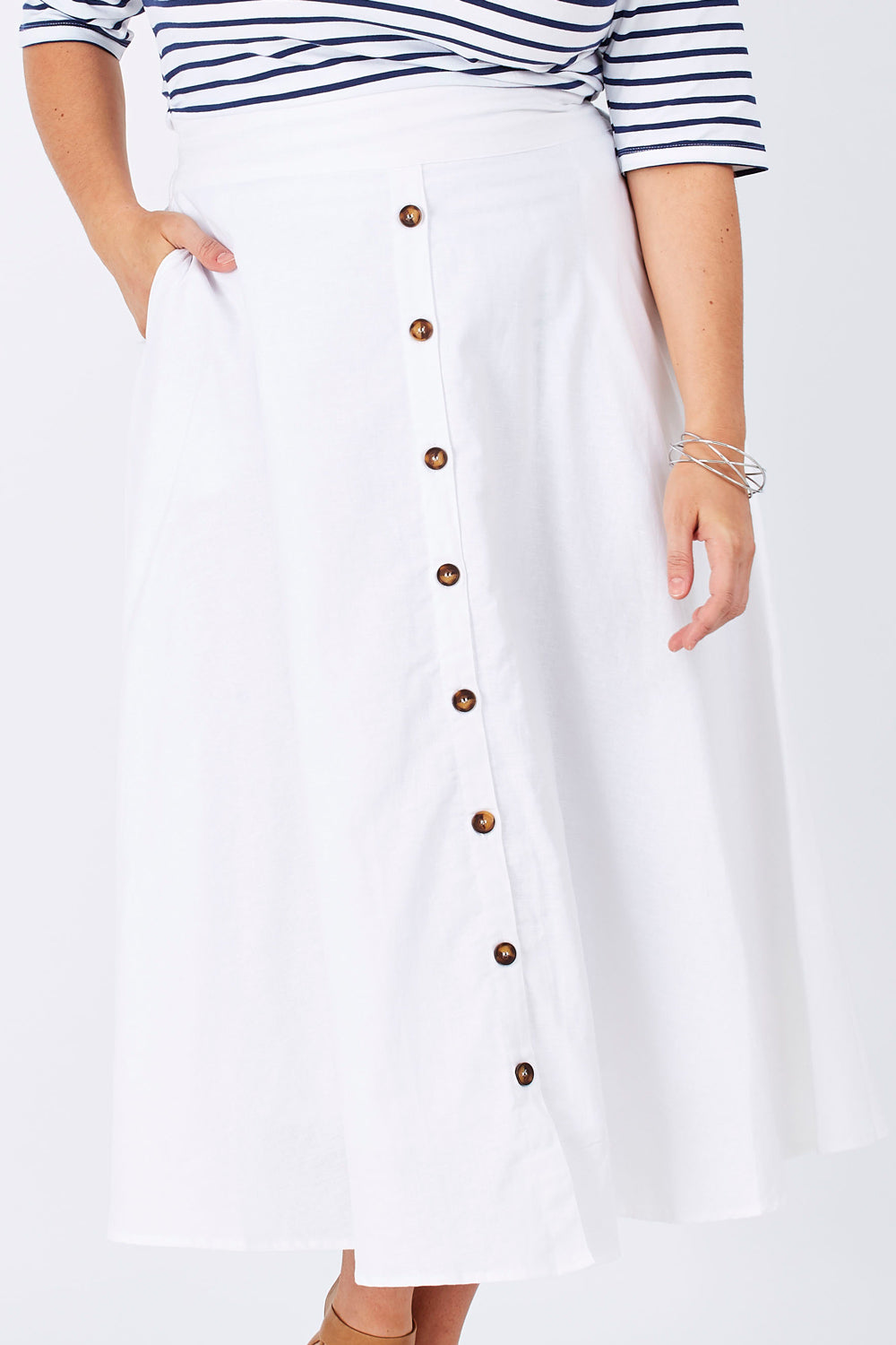 Model Mae wearing size 16 of The Button Up Midi Skirt in colour White (White), from the front, cropped image