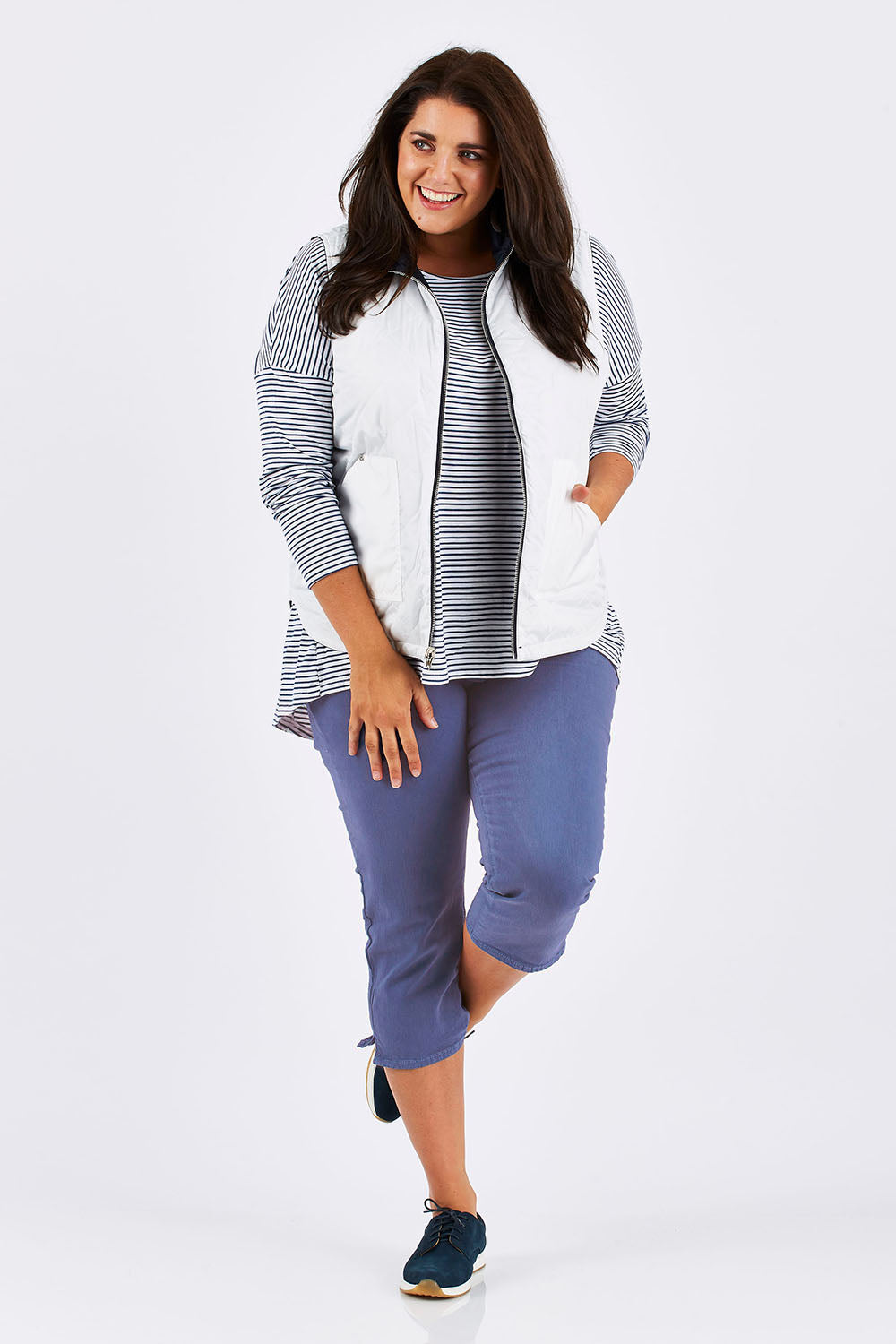 Model Mae wearing size 18 of The 3/4 Stretch Jean in colour Blue (Blue), from the front, showing the whole outfit