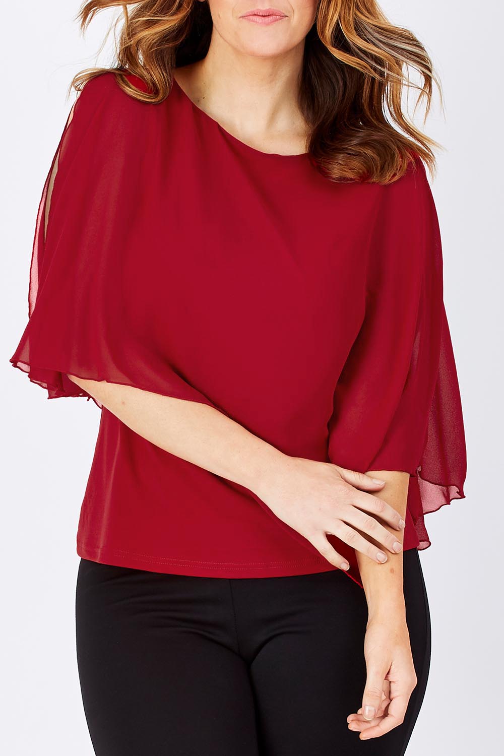 Model Laura wearing size 12 of The Overlay Top in colour Red (Red), from the front, cropped image