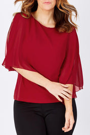 Model Laura wearing size 12 of The Overlay Top in colour Red (Red), from the front, cropped image
