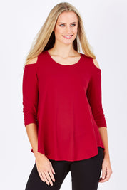 Model Maddy wearing size 10 of The Cut Out Shoulder Top in colour Red (Red), from the front, cropped image