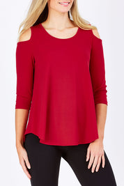 Model Maddy wearing size 10 of The Cut Out Shoulder Top in colour Red (Red), from the front, cropped image