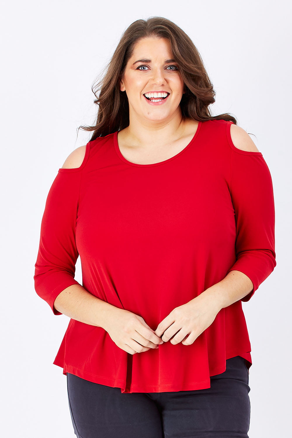Model Mae wearing size 16 of The Cut Out Shoulder Top in colour Red (Red), from the front, cropped image
