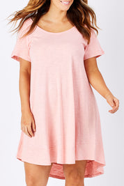 Model Laura wearing size 12 of The Swing Dress in colour Pink (Pink), from the front, cropped image