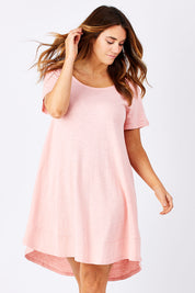 Model Laura wearing size 12 of The Swing Dress in colour Pink (Pink), from the front, cropped image