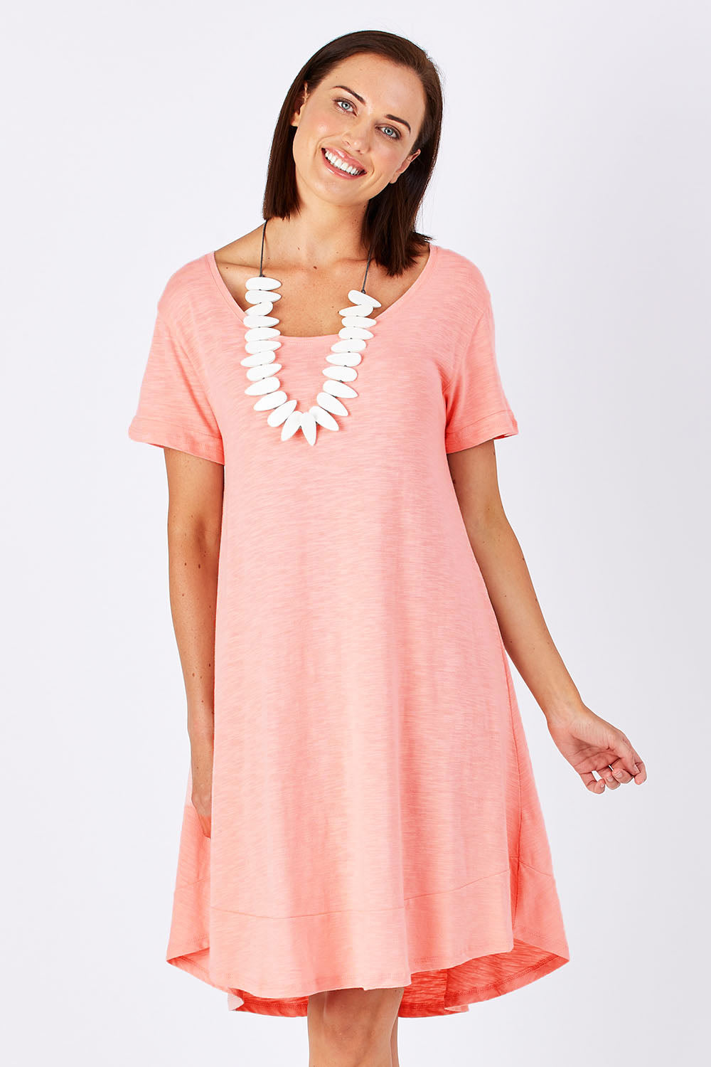 Model Perrie wearing size 10 of The Swing Dress in colour Pink (Pink), from the front, cropped image