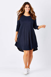 Model Laura wearing size 12 of The Long Sleeve Swing Dress in colour Navy (Blue), from the front, showing the whole outfit