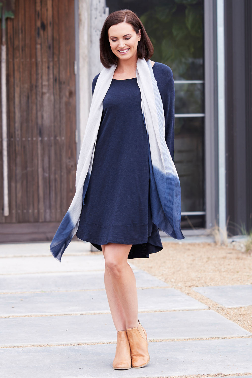 Model Perrie wearing size 10 of The Long Sleeve Swing Dress in colour Navy (Blue), from the front, showing the whole outfit
