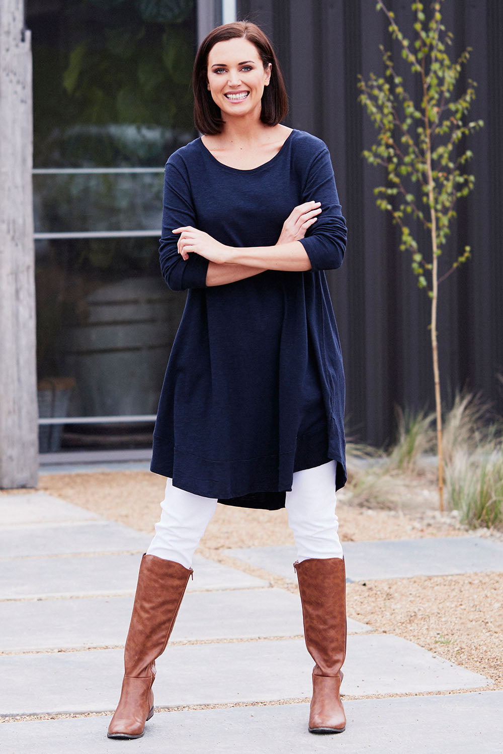 Model Perrie wearing size 10 of The Long Sleeve Swing Dress in colour Navy (Blue), from the front, showing the whole outfit