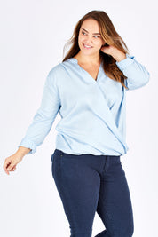 Model Sophie wearing size 14 of The Daily Cross Over Top in colour SkyBlue (Blue), from the front, cropped image