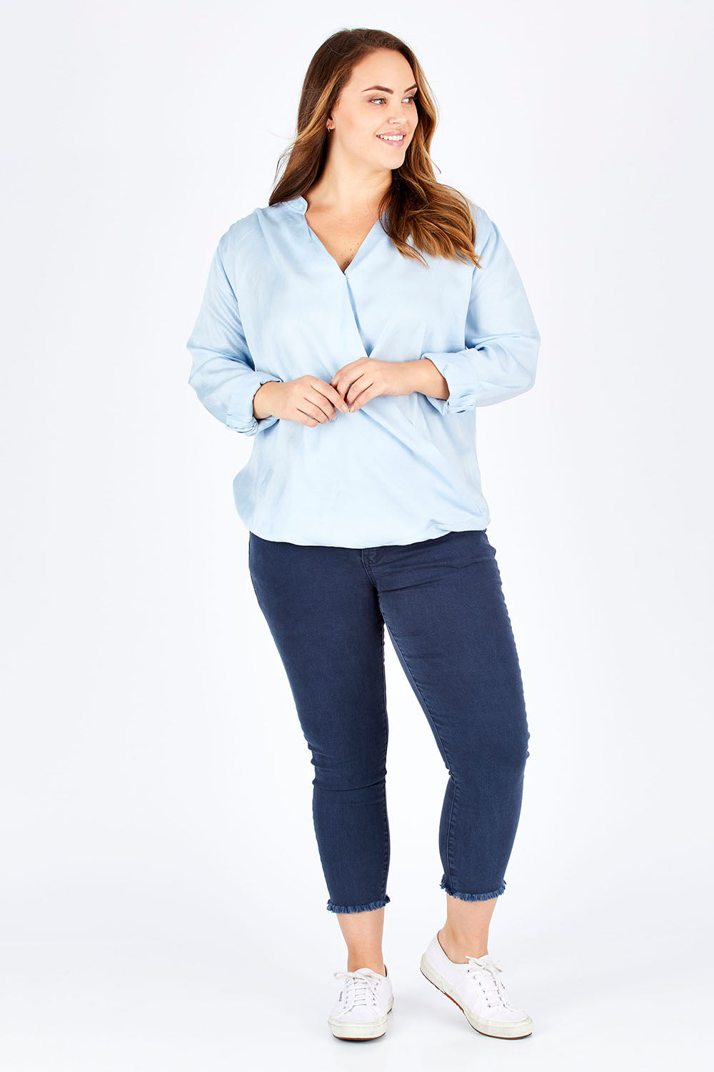 Model Sophie wearing size 14 of The Daily Cross Over Top in colour SkyBlue (Blue), from the front, showing the whole outfit