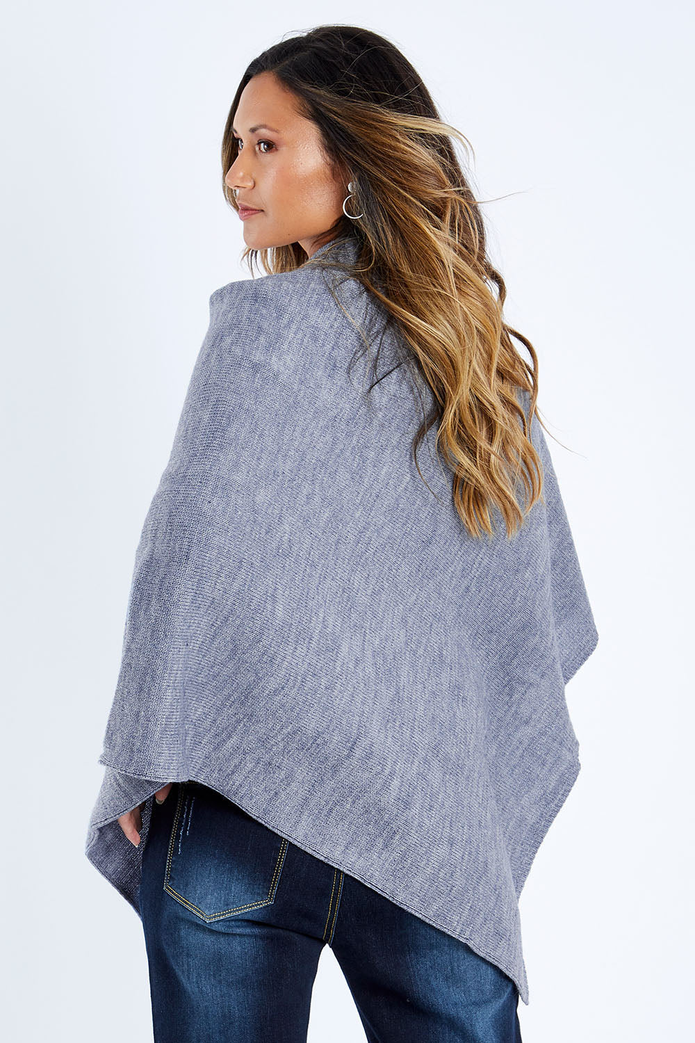 Model Kimberley wearing size S of The Perfect Poncho in colour Bluemarle (Blue), from the back