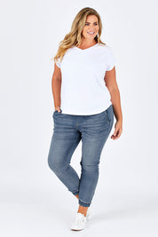 Model Fiona wearing size 16 of The Pull On Jogger Jean in colour Denim (Blue), from the front, showing the whole outfit