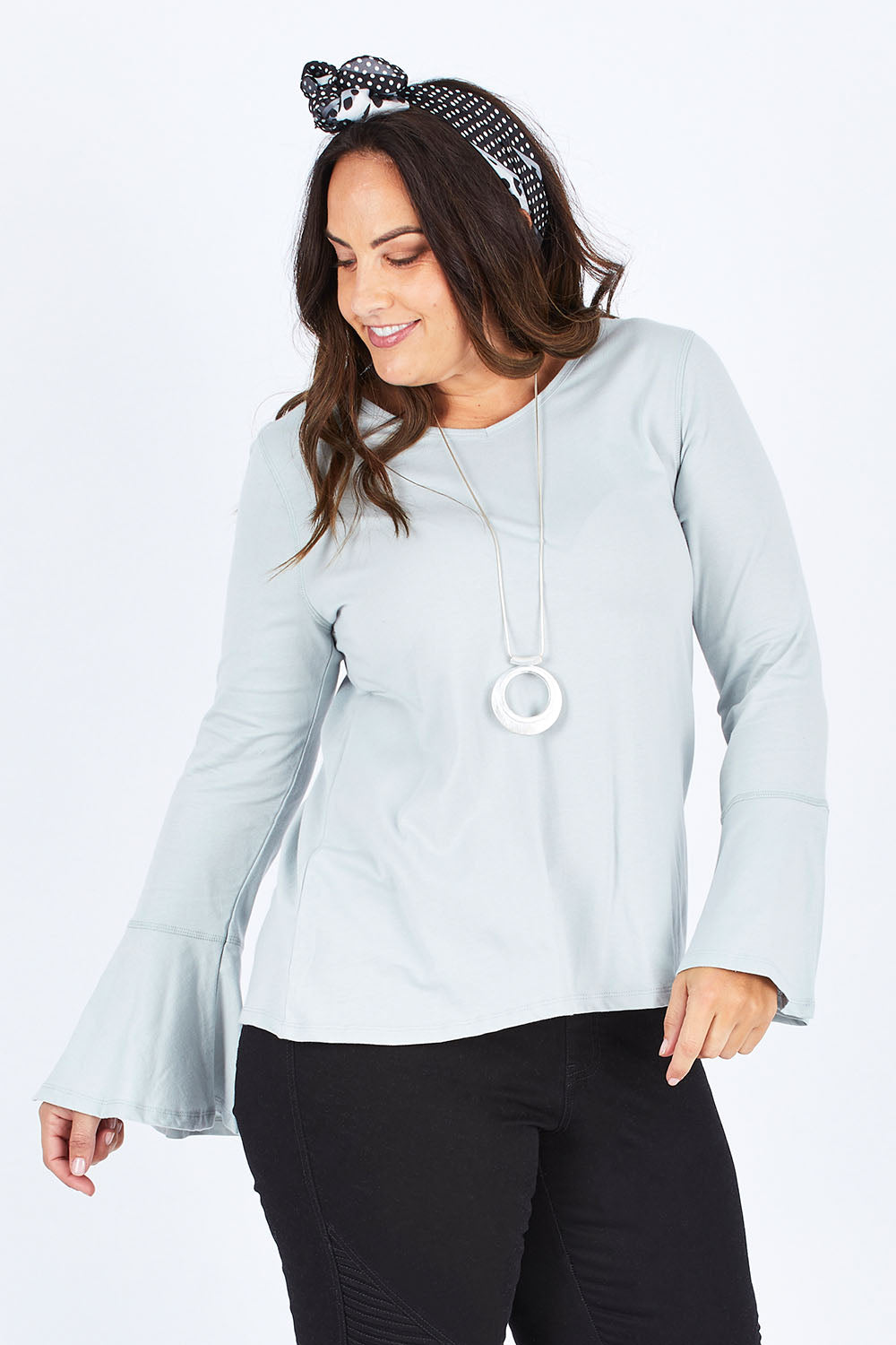Model Stacey wearing size 12 of The Bell Sleeve Top in colour Grey (Grey), from the front, cropped image