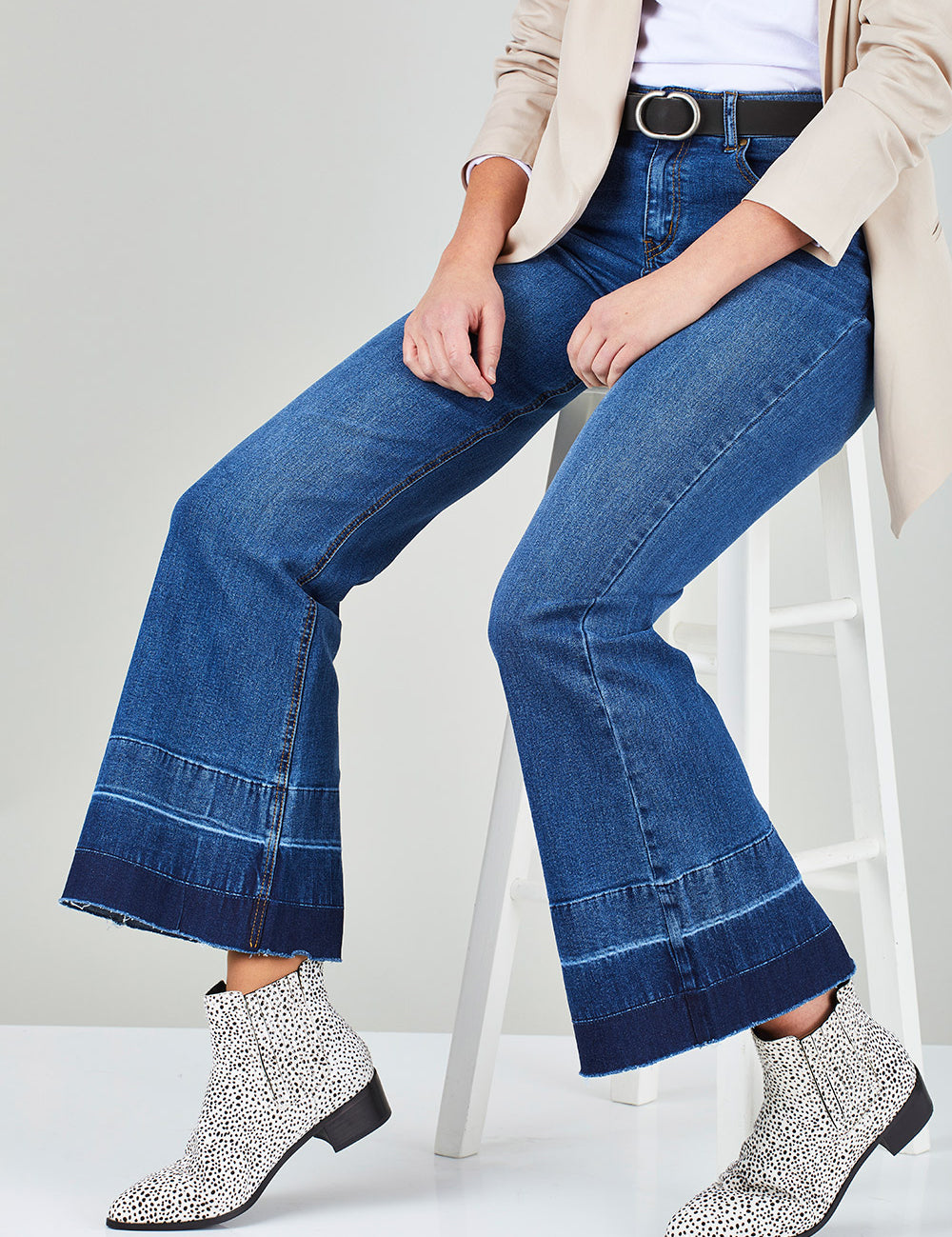 Model Chelsea wearing size 10 of The Bootcut Jean in colour Denim (Blue), from the front, cropped image