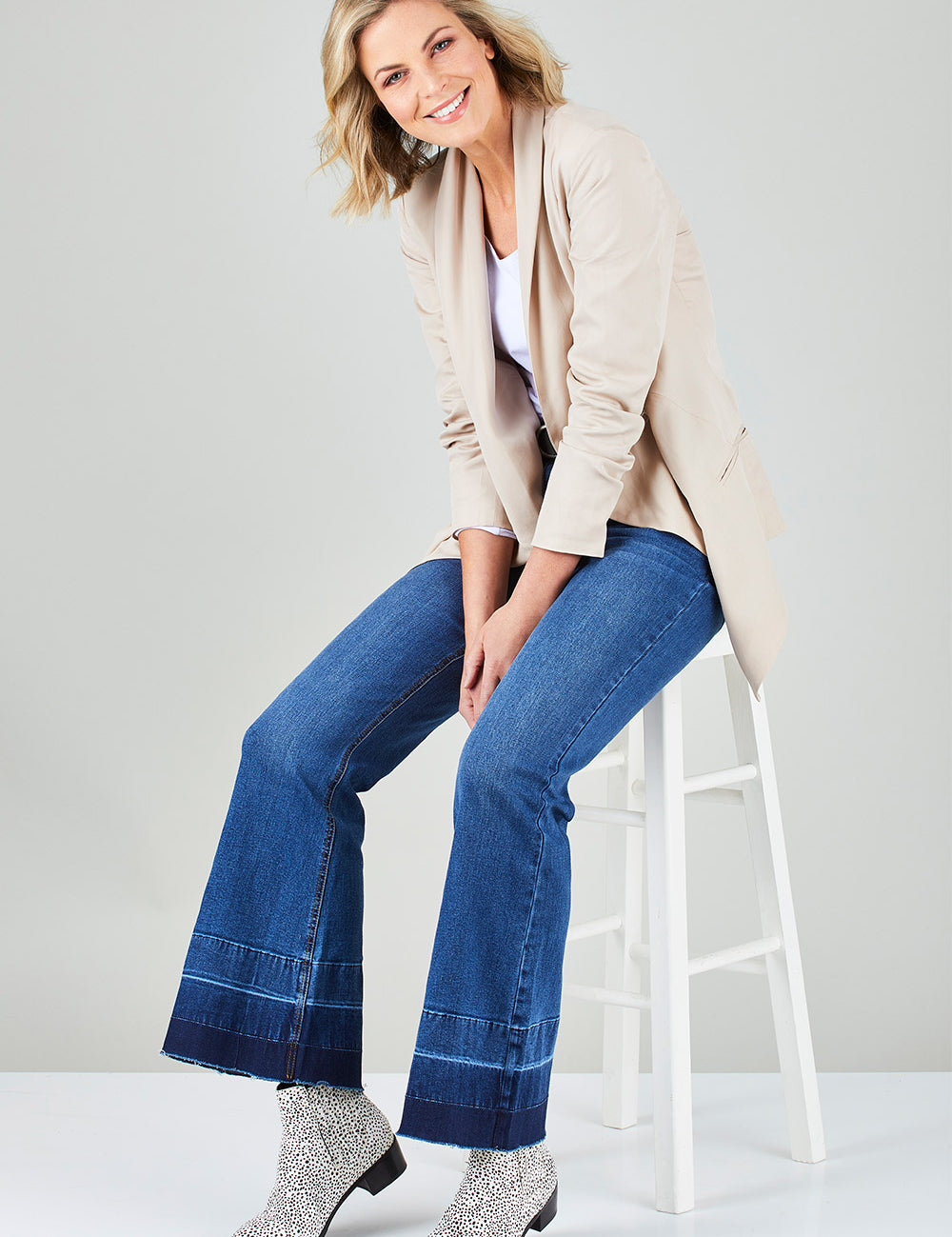 Model Chelsea wearing size 10 of The Bootcut Jean in colour Denim (Blue), from the front, showing the whole outfit