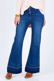 Model Riina wearing size 10 of The Bootcut Jean in colour Denim (Blue), from the front, cropped image