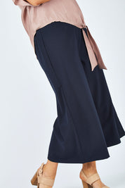 Model Laura wearing size 14 of The Keepsake Culotte in colour Navy (Blue), from the front, cropped image
