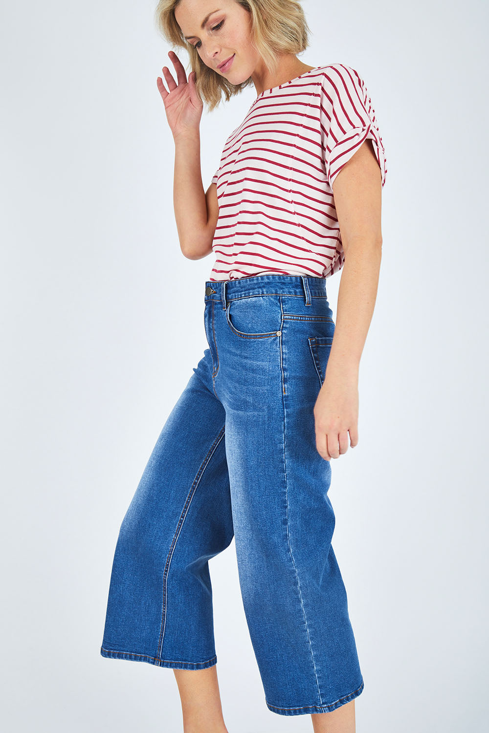 Model Chelsea wearing size 10 of The Wide Leg Jean in colour Denim (Blue), from the front, cropped image
